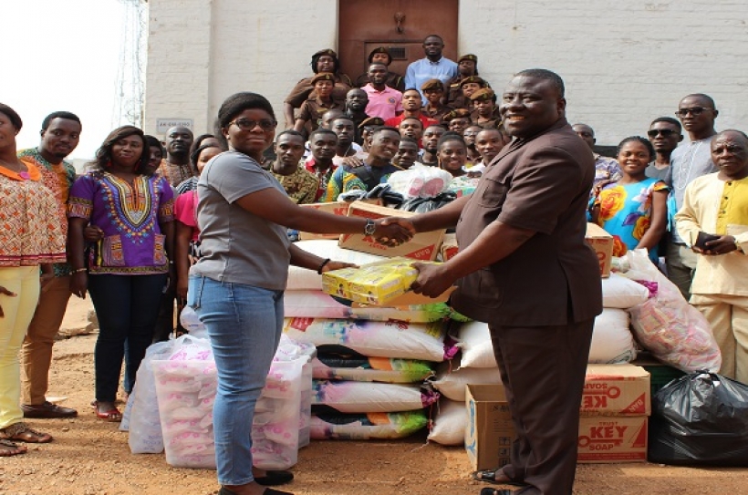 PASTOR THOMAS TETE ASARE (RIGHT) PRESENTING THE ITEMS TO DSP ADWOA AMOFA AGYENA (LEFT)