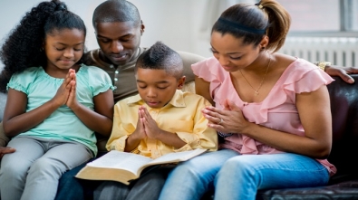 black family praying together