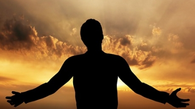 Man praying, meditating in harmony and peace at sunset. Religion, spirituality, prayer, peace.