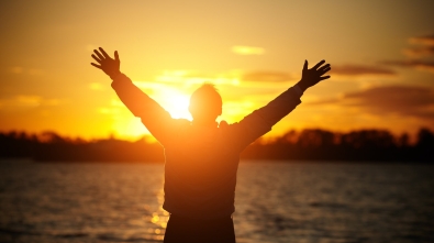 1-26-CH-Man-arms-raised-in-praise-to-God-at-sunset-over-water