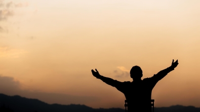 silhouette-of-a-man-lift-hands-up-and-prayer-and-worship-god-at-sunset-concept-of-religion-free-photo